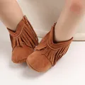 Close-up of brown suede baby boots with stylish tassel detailing and zipper closure. - Brown