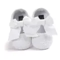 Detailed view of white embroidered baby princess shoes with a large soft white bow - Flats / 12cm / White