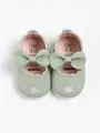 Detailed view of green baby princess shoes with floral embroidery and soft leather bows - Green