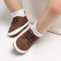Close-up detail of brown soft-sole baby walking shoes with decorative stitching and laces - Inner Length 12cm / Brown