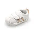 Close-up view of white baby walking shoe with gold stripes, velcro straps and soft sole - Platinum