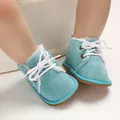 Close-up of blue suede baby boots with white laces and cozy faux fur lining - Light Blue