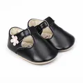 Close-up of black T-strap baby walking shoes decorated with a cute pink flower - 11cm / Black