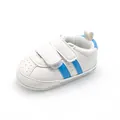 Detailed side view of white baby walking shoes with blue stripes and velcro straps - White Blue