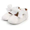 Close-up view of white patent leather baby girl princess shoes with large ribbon bows - 12cm / Princess Shoes (M1978) / White