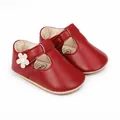 Detailed view of red leather baby girl walking shoes with a delicate flower motif - 11cm / Red