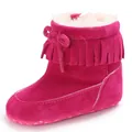 Close-up of pink baby snow boots with decorative fringe tassel and warm white faux fur lining - Peach Red