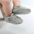 Close-up of knitted baby walker shoes with cute embroidered cat face and non-slip sole - Gray