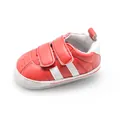 Detail view of breathable red baby walking shoe with non-slip sole and white stripes - Red