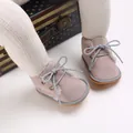 Macro detail of pink baby walking boots featuring warm fur lining and grey laces. - Gray