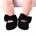 Detailed macro shot of black knit baby walker shoes featuring a large decorative bow - 12cm / Bow Style / Black
