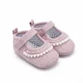 Detailed view of pink fabric infant walker shoes with white pom-poms and polka dot lining - Insole Length 11cm / Pink