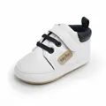 Detailed close-up of a white baby walking shoe with navy blue heel and Velcro strap - Inner Length 11cm / White