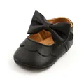 Detailed view of black PU leather baby princess shoes featuring a large decorative bow. - 11cm / Black