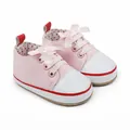Detail of pink baby walking shoes with satin bow and white faux leather toe cap. - 11cm / Pink