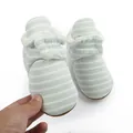 Detail view of baby striped winter boots with warm plush fleece lining and soft sole. - White Green