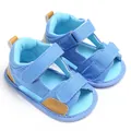 Detailed macro view of blue denim baby sandals with adjustable velcro straps. - Light Blue