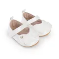 Primer plano detallado de zapatos de princesa blancos para bebé con lazo de terciopelo - Blanco