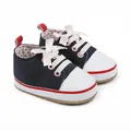 Detailed view of navy blue baby girl walking shoes featuring soft pink ribbon bow laces - 11cm / Blue
