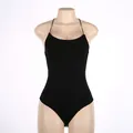 High-quality detail of a sexy backless black halter neck bodysuit displayed on a mannequin. - S / Tops / Black