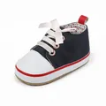 Detailed view of navy blue baby girl walking shoe with pink silk bow and polka dot lining - Inner Length 13cm / Blue