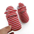 Close-up of soft red striped baby winter boots held by hand for size reference. - 13cm (9-12Months) / Red