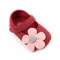 Close-up of burgundy knitted baby girl princess shoes with a soft pink flower detail - Inner Length 13cm/45g / Red + Pink Flower