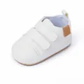 Detailed view of white faux leather baby walker shoes featuring double velcro straps - Insole Length 11cm / White