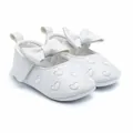 Close-up view of white baby girl princess shoes with embroidered heart patterns and large bow - 11cm / White