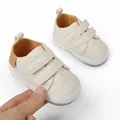 Detail view of cream-colored soft-sole baby shoes showing velcro straps and stitching - 11cm / Beige