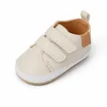 Detail view of cream baby walking shoes with dual velcro straps for infants 0-1 years - Insole Length 11cm / Beige