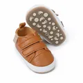 Detailed view of brown baby sneakers showing non-slip sole and soft leather texture - Brown