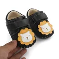 Close-up of black baby pre-walker shoes with anti-slip rubber sole and lion design - 11cm/Size 12 / Black (6617)