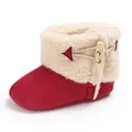 Detailed view of red baby winter snow boot with warm sherpa lining and wooden button - Red