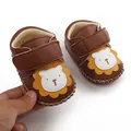 Macro view of brown faux leather baby shoes featuring a cute lion cartoon character design - 11cm/Size 12 / Coffee (6617)