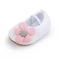 Detailed view of white fleece baby walking shoe with a soft pink flower decoration - White