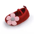 Detailed view of red fuzzy baby walking shoe featuring a large pink fabric flower - Red
