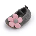 Close-up of baby soft sole fleece walking shoes with a pink flower decoration. - Gray
