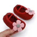 Detailed close-up of red soft-sole fleece baby shoes featuring a cute pink flower decoration - 11cm (Size 1) / Red