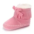 Close-up of pink fringed baby boots with soft sole and white plush lining - Pink