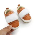 Close-up of brown baby princess shoes with white faux fur strap and soft non-slip sole. - Caramel color