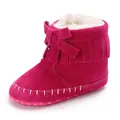 Detailed view of a fuchsia baby fringe moccasin boot with soft fur lining and bow detail - 11cm / Rose Red