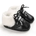 Detailed view of black infant soft sole baby boots with white faux fur lining - Black
