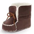 Close-up of warm brown suede baby winter boots with soft white fleece lining and bow - Brown