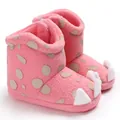 Close-up of pink baby winter boots with soft coral fleece and decorative claws - Pink