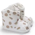 Close-up of white plush baby snow boots with cute claw design and polka dots - White