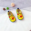 Detailed view of yellow children's canvas slip-on shoes featuring cute cartoon firetruck prints - Yellow Car