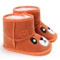 Detailed macro view of warm brown winter baby boots featuring a cartoon bear face - Orange