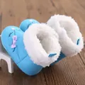 Detail view of blue baby winter snow boots with white faux fur lining and purple bow. - 11cm / Blue