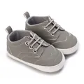 Close-up of gray baby walking shoes featuring soft anti-slip soles and wingtip stitching - Inner Length 12cm / Gray